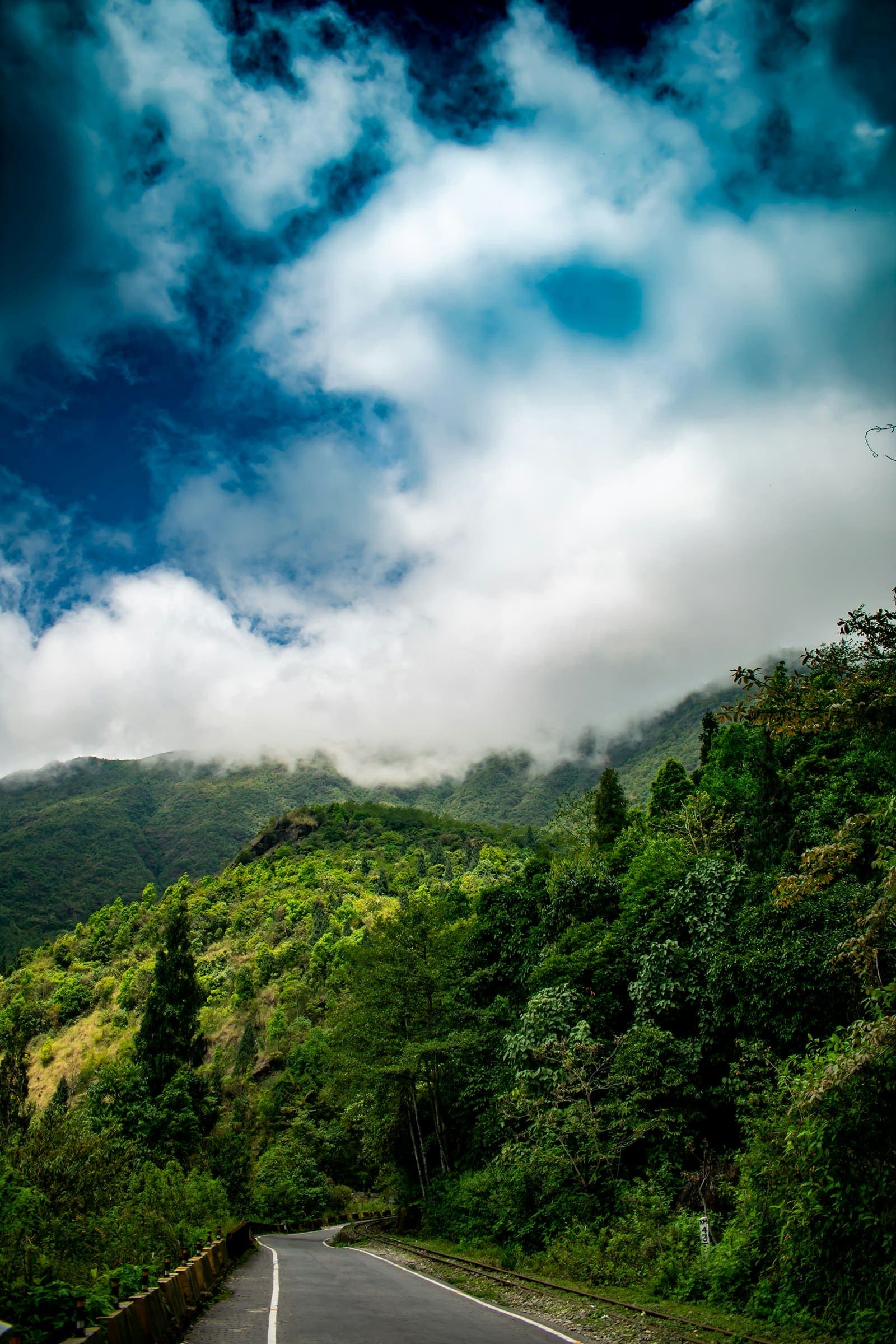 Misty green hills and a winding road in North East India